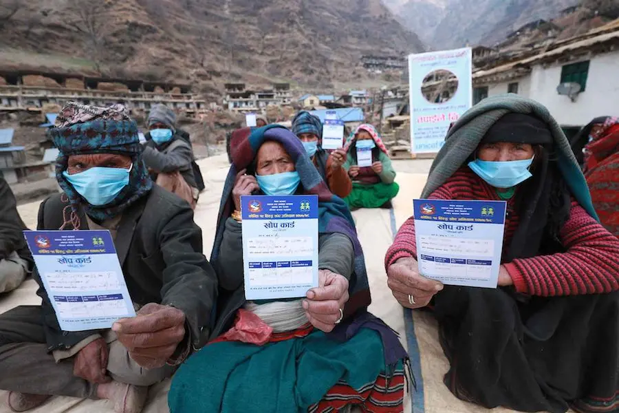 People with Masks Holding Up Cards