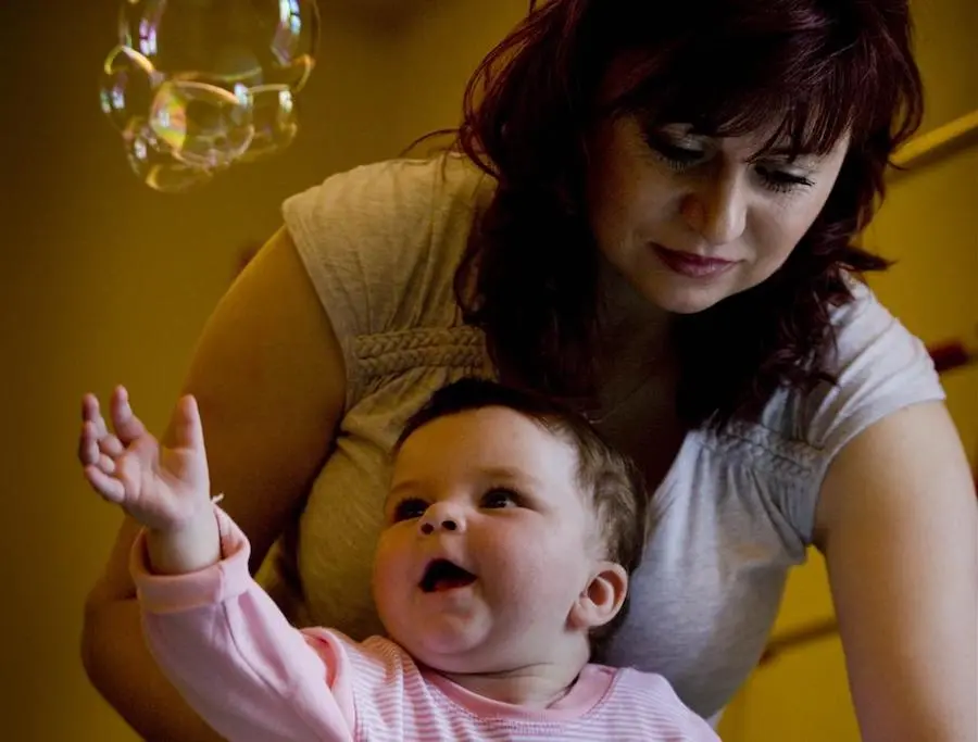 Julia assists her 1-year-old daughter, Dania, who has a motor delay condition, during a therapy session at the UNICEF-supported Voinicel Centrer in Chisinau, Moldova. Julia assists her 1-year-old daughter, Dania, who has a motor delay condition, during a therapy session at the UNICEF-supported Voinicel Centrer in Chisinau, Moldova. 