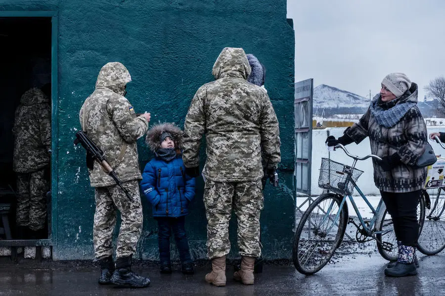 A child crossing a checkpoint overseen by the Ukrainian military in Donetsk Oblast, Ukraine, November 2017. Lines at the checkpoint can last an entire day for people trying to cross. A child crossing a checkpoint overseen by the Ukrainian military in Donetsk Oblast, Ukraine, November 2017. Lines at the checkpoint can last an entire day for people trying to cross.