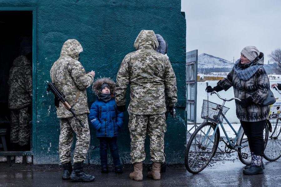A child crossing a checkpoint overseen by the Ukrainian military in Donetsk Oblast, Ukraine, November 2017. Lines at the checkpoint can last an entire day for people trying to cross. 