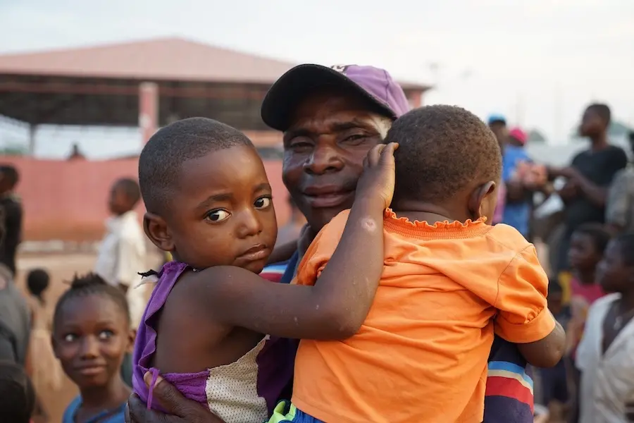 A father smiles after reuniting with his children at the Cacanda reception center for refugees in Dundo, northern Angola. unicef, father's day, democratic republic of the congo, refugees, world refugee day, angola, kasai
