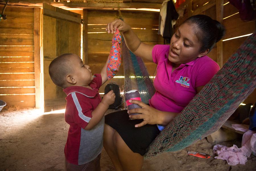 On 14 August 2016 in Belize, Abner Choc, 2, and Melisha, a facilitator from the UNICEF-supported Roving Caregivers Program (RCP), play during her visit to his home, in San Felipe Village in the Toledo region.