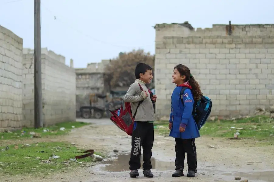 Zahra, 7, walks to school with her friend in Karm Al- Nezha neighborhood of east Aleppo. “I choose the long way to school because it’s less muddy,” she says. Photo: UNICEF/ Syria 2018/ Khudr Al- Issa Zahra, 7, walks to school with her friend in Karm Al- Nezha neighborhood of east Aleppo. “I choose the long way to school because it’s less muddy,” she says. Photo: UNICEF/ Syria 2018/ Khudr Al- Issa