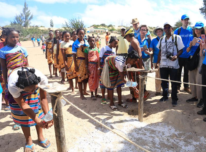 Mother Leaders wash hands with ash before a celebration welcoming a delegation from UNICEF USA and Zonta International in Tanandava, Madagascar. 