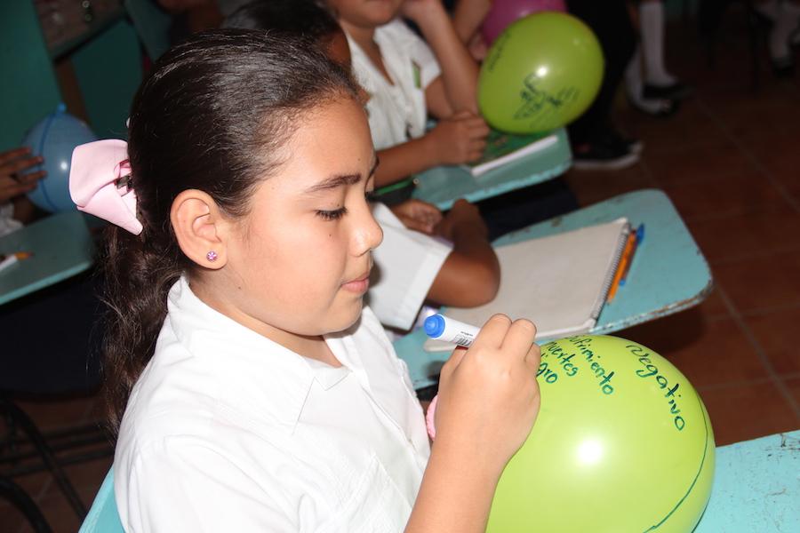 Girl Writing on Balloon