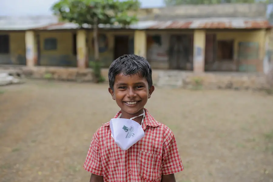 Child Smiling with Mask Down