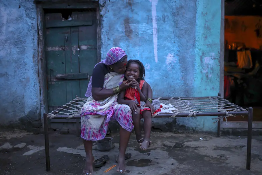 Woman and Child Smiling on Bed