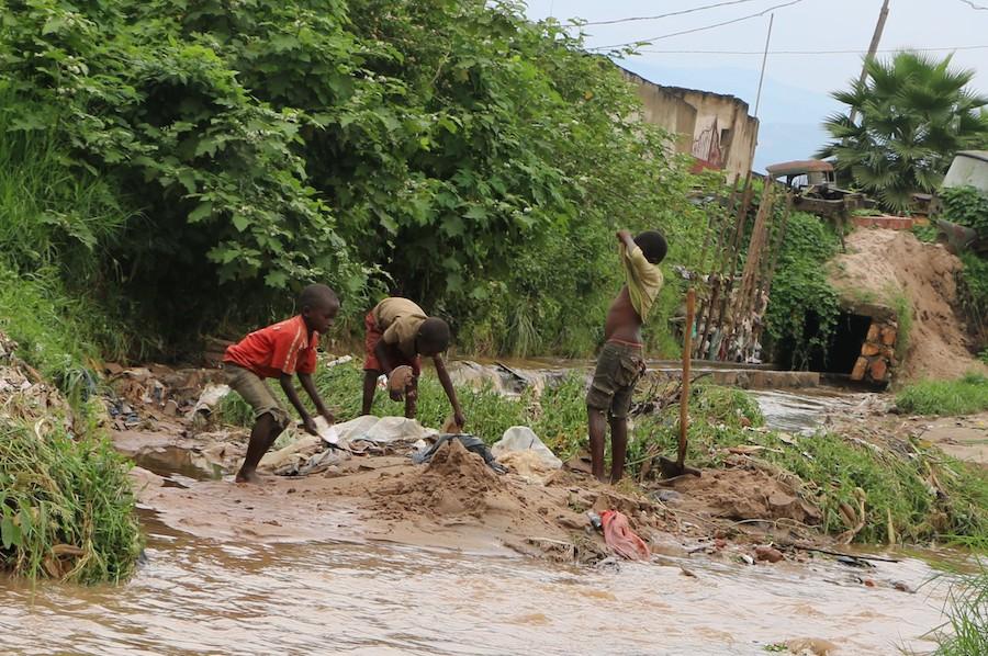 On January 29, 2020, boys play in the muddy ruins of their neighborhood after massive flooding in Bujumbura, Burundi. 