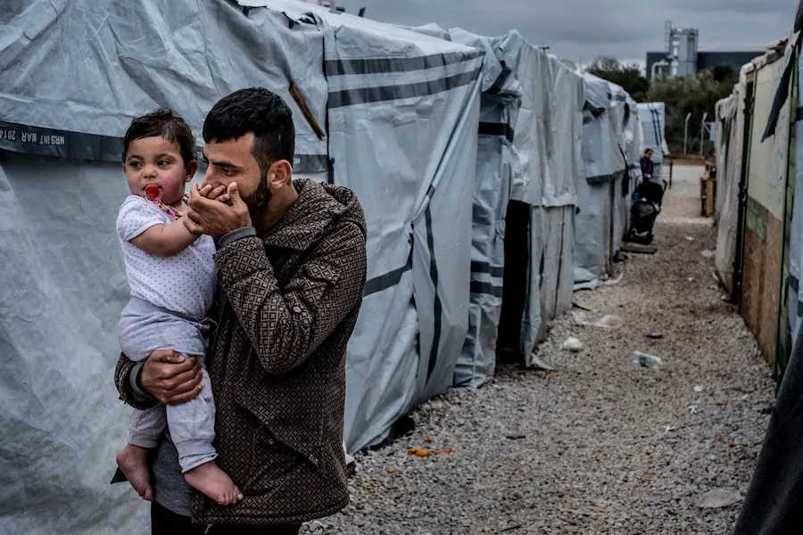 Iraqi Kurdish refugee Barzan Hassan, 24, from Erbil, Iraq holds 1-year-old Yamar outside their shelter in Ritsona refugee camp near Chalcis, Greece in March 2017. unicef, iraq, greece, father's day, world refugee day, refugee camps