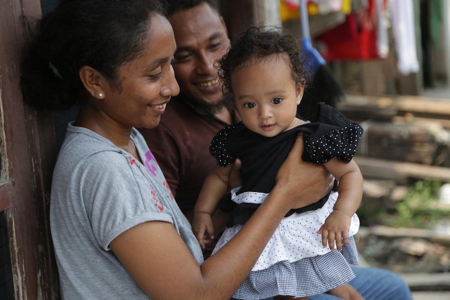 Parents with their child in Jakarta, Indonesia who just received her polio immunization through a UNICEF-supported immunization drive.