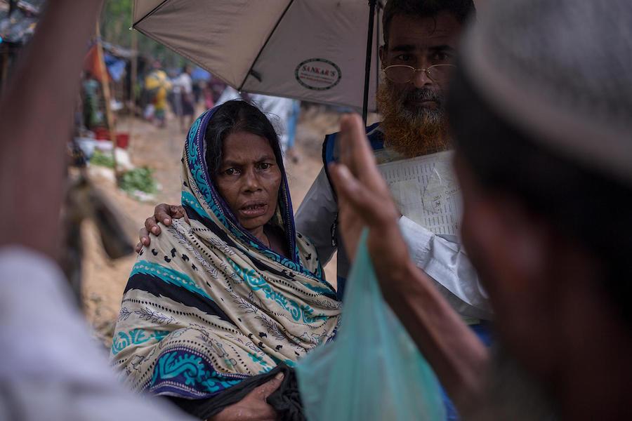 Lost in a vast sea of makeshift shelters, Rohingya refugee Johora carries her 4-day-old granddaughter through the Kutupalong refugee camp in Cox's Bazar, Bangladesh.