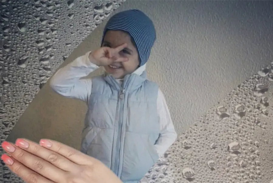Child Holding Up Peace Sign