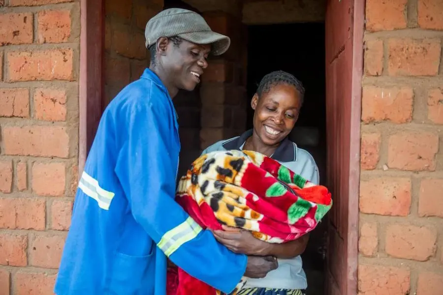 Two People Holding Blanket