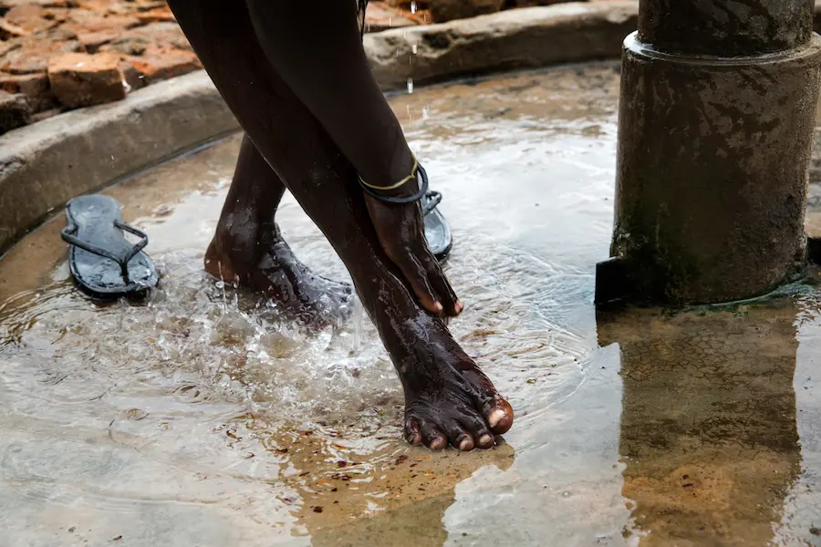 A woman washes herself at a water pump located at the Machakos Primary School, Bentiu, South Sudan, July 2017. A woman washes herself at a water pump located at the Machakos Primary School, Bentiu, South Sudan, July 2017.