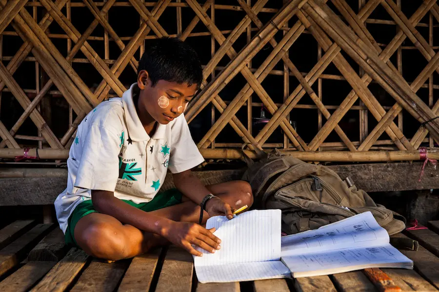 Boy Writing in Notebook