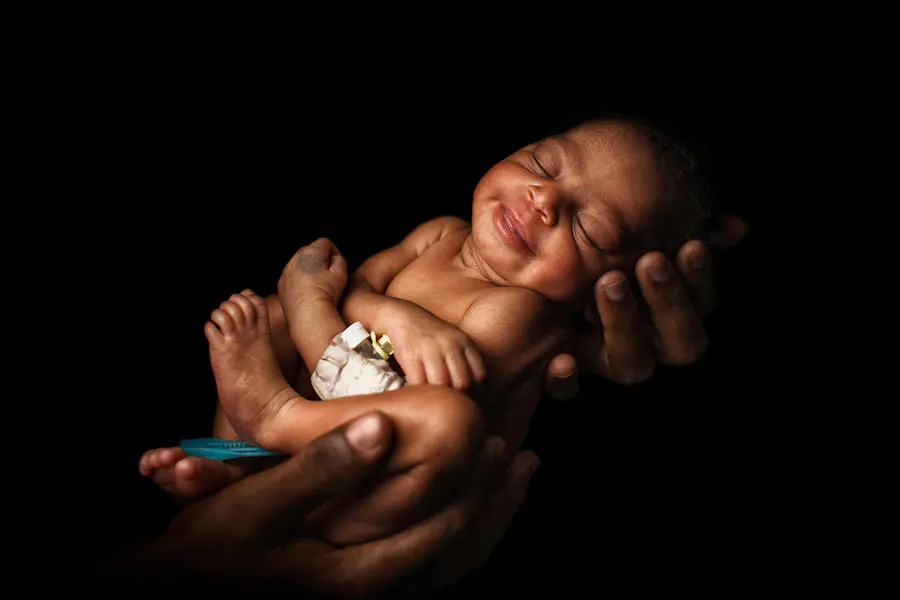 Four-day-old Kadia sleeps in her mother's embrace in Bougouni, Mali in March 2018. Four-day-old Kadia sleeps in her mother's embrace in Bougouni, Mali in March 2018.