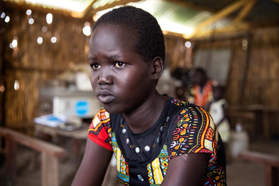 Mary, 15, sits in a classroom at the Machakos Primary School, Bentiu, South Sudan, July 2017. 