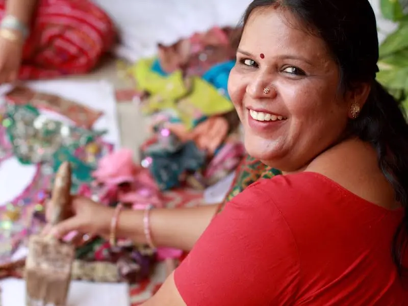 Woman Holding Paintbrush and Smiling