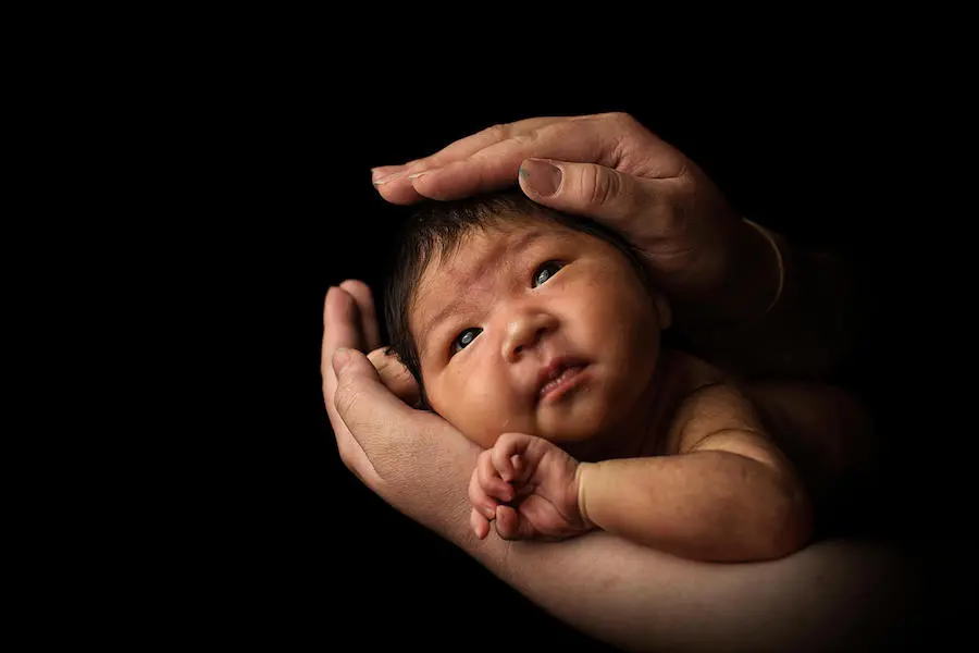 Bayarmaa holds her two-week-old baby in her living room in Murun, Mongolia in March 2018. Bayarmaa holds her two-week-old baby in her living room in Murun, Mongolia in March 2018.