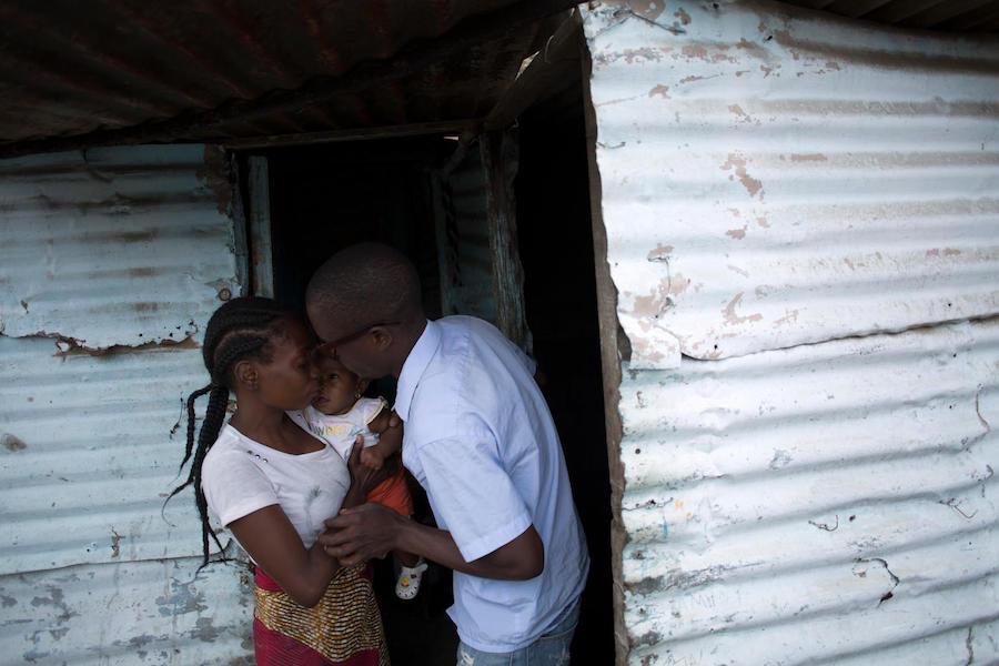 Einosio, 24, a fecal sludge operator, says goodbye to his wife, Aida, and their 6-month-old daughter, Melucha, in Maputo, Mozambique in September 2017.
