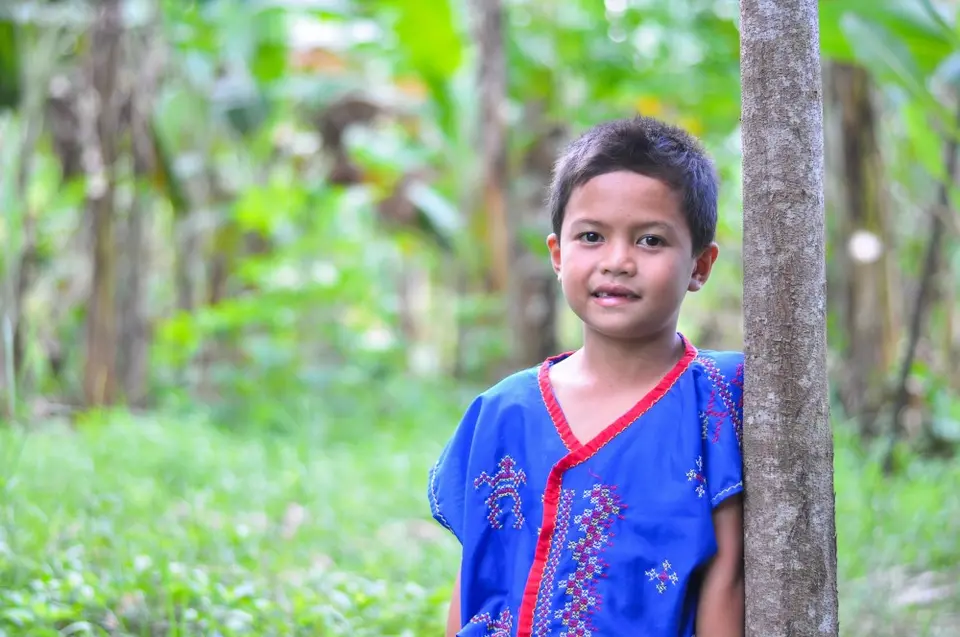 Boy Leaning Against Tree