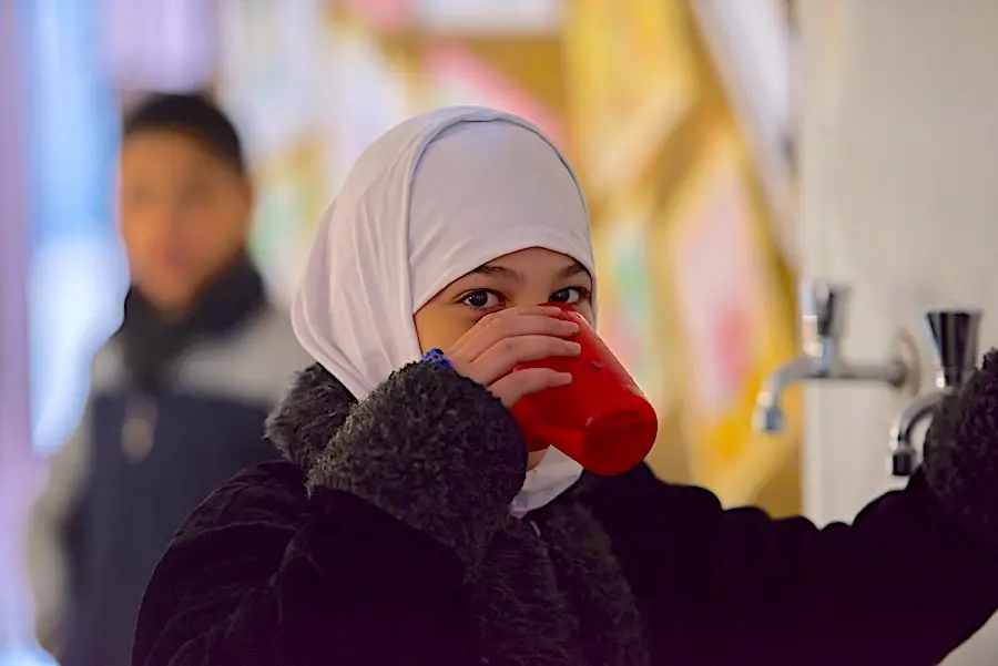Afnan, 11, and her family were displaced from their home in rural Damascus four years ago. Her father collects drinking water every day from a nearby mosque. Afnan, 11, and her family were displaced from their home in rural Damascus four years ago. Her father collects drinking water every day from a nearby mosque.