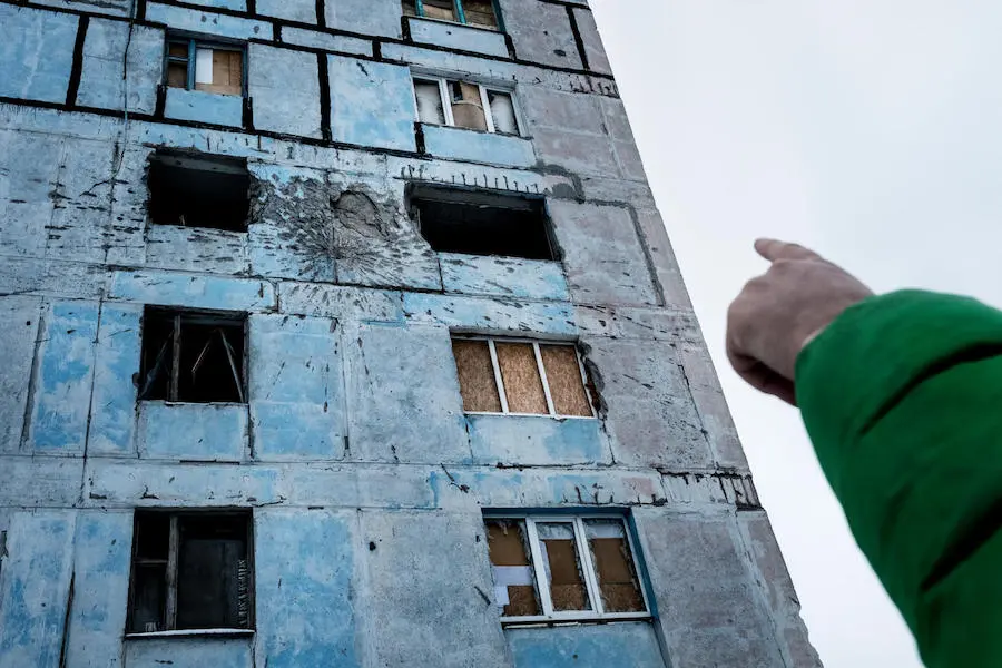 Vadim, 9, points to damage on his old home, in a building known locally as the "coloring book" in Avdiivka, Dontesk Oblast, Ukraine, November 2017. Vadim, 9, points to damage on his old home, in a building known locally as the "coloring book" in Avdiivka, Dontesk Oblast, Ukraine, November 2017.