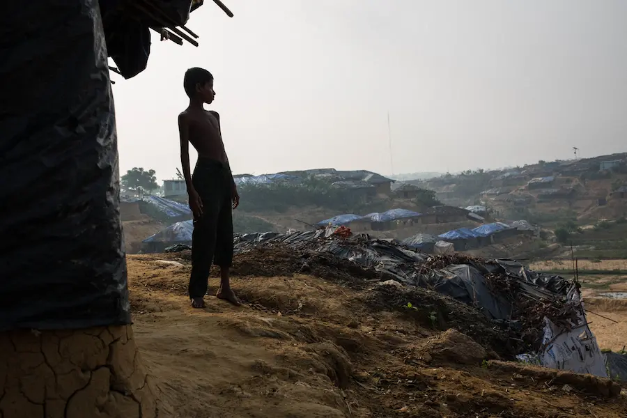 Omar, 8, stands outside the mud hut he shares with his parents and four siblings in Kutupalong Camp for Rohingya refugees in Bangladesh in May 2017. Omar, 8, stands outside the mud hut he shares with his parents and four siblings in Kutupalong Camp for Rohingya refugees in Bangladesh in May 2017.