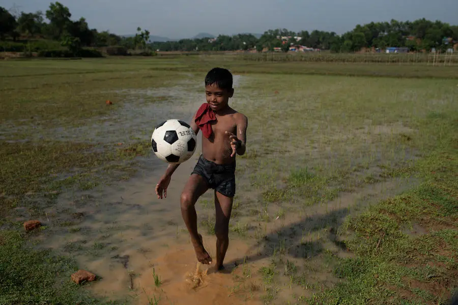 After a heavy rain that saturated the ground, Hafizul Mustafa, 11, a Rohingya refugee from Myanmar, plays soccer in Balukhali camp, Cox's Bazaar District, Bangladesh on 4 May 2018. unicef, rohingya, soccer balls, football, refugees, bangladesh