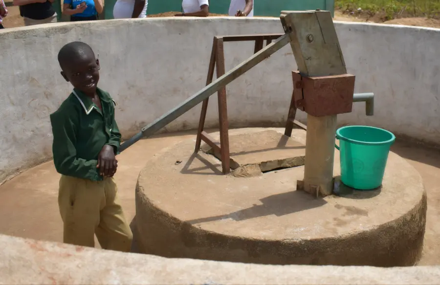 A young boy named Coker draws water from a well. UNICEF Sierra Leone. 