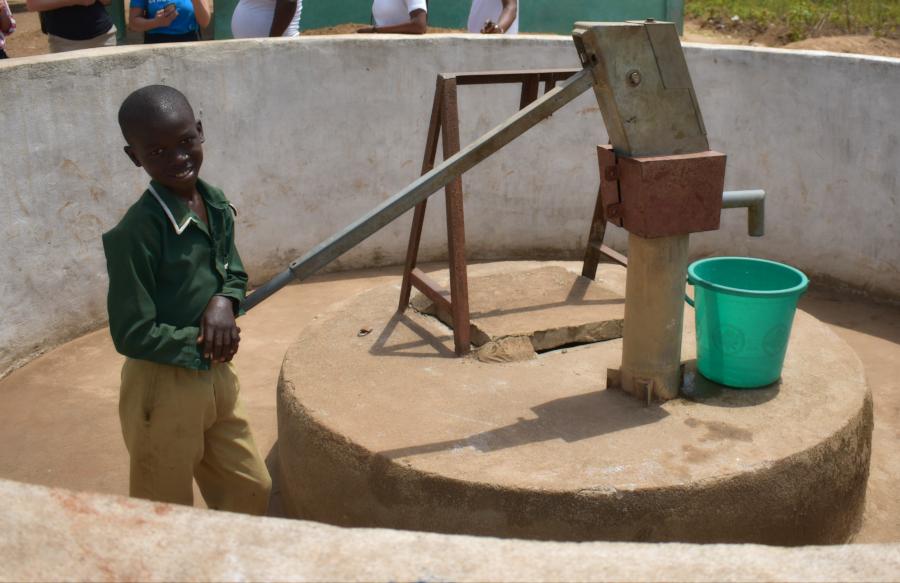 A young boy named Coker draws water from a well. UNICEF Sierra Leone. 