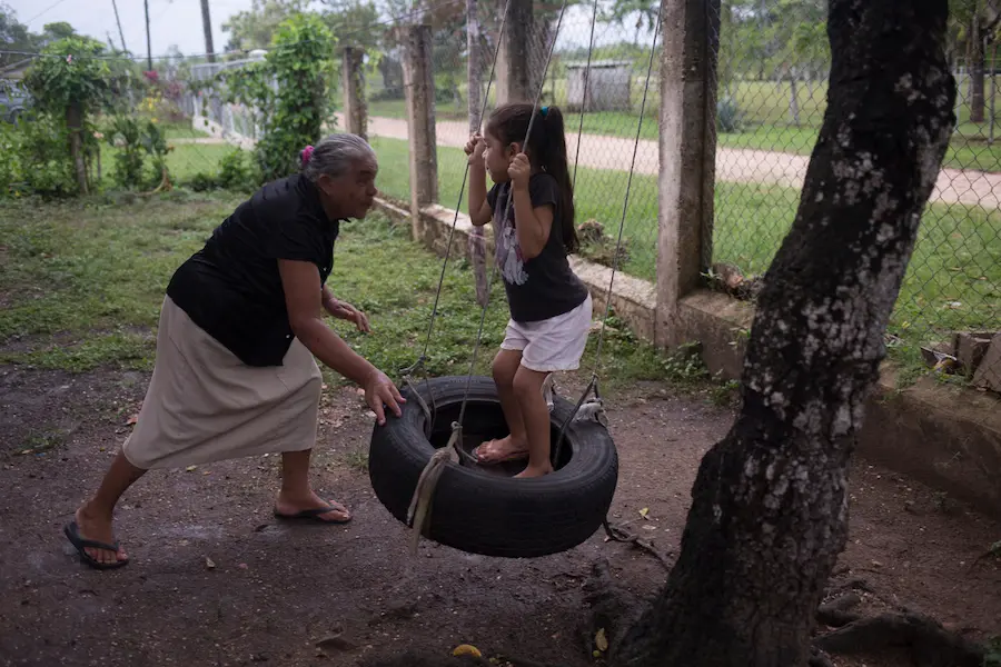 Conzuelo pushes her great-granddaughter Allizon, 4, on a home-made swing in Cayo District, Belize, August 2016. Because Allizon’s mother works full time, Conzuelo is Allizon’s primary caregiver and spends many hours interacting with her every day. Conzuelo pushes her great-granddaughter Allizon, 4, on a home-made swing in Cayo District, Belize, August 2016. Because Allizon’s mother works full time, Conzuelo is Allizon’s primary caregiver and spends many hours interacting with her every day.