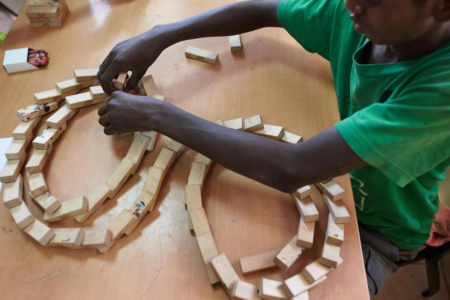 Abdellah, 15, makes crafts from recyclable materials in an arts &amp; crafts room at UNICEF-supported Caritas Center for Children in the city of Djibouti. Djibouti in April 2018.