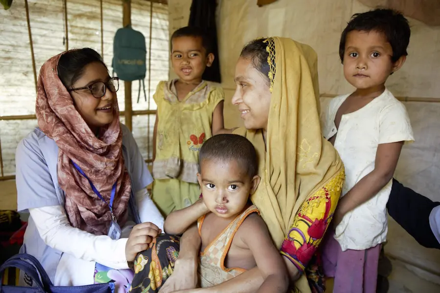 Two Women Smiling with Children