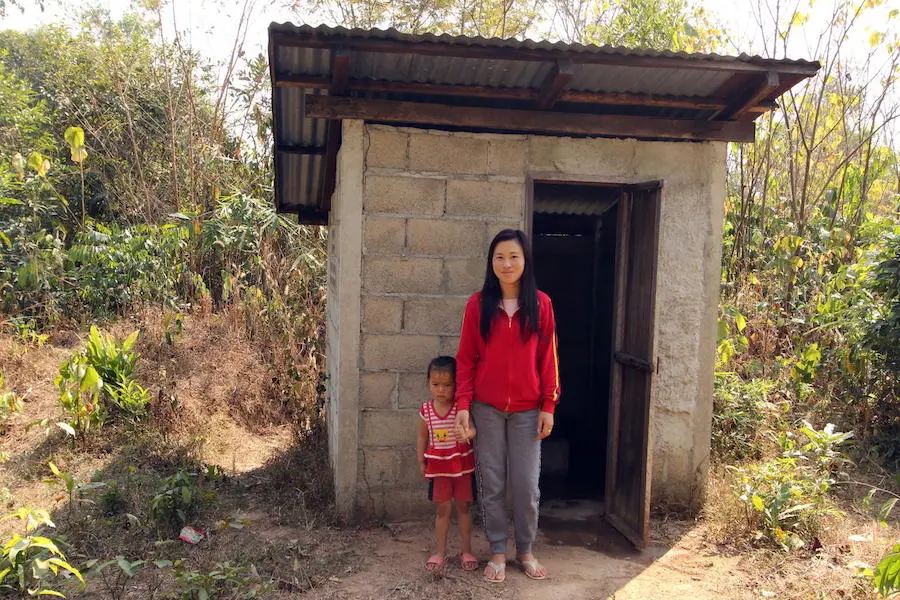 Ms. Hing, 31, and her 4-year-old daughter, Than, outside their new toilet installed by UNICEF and partners in Namdeau village, Bolikhamxay province, Laos in 2018. UNICEF, sanitation, World Toilet Day, Laos