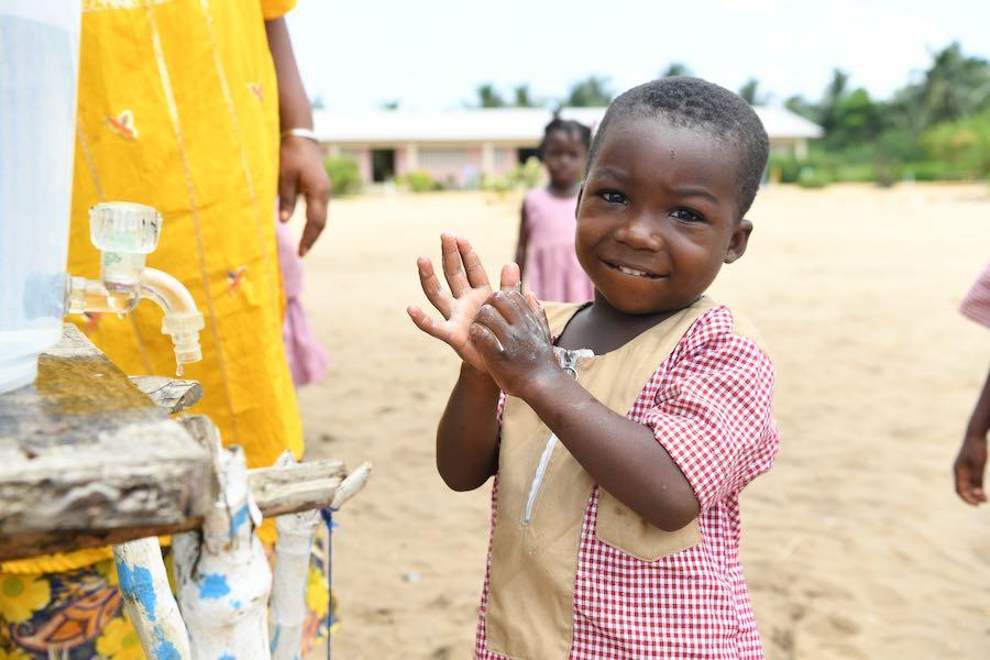 A young boy is washing his hands at school in Essankro, in the South East of Côte d'Ivoire. In Côte d'Ivoire, regular handwashing with soap and water is not common yet this simple gesture saves lives. Simply washing hands with soap and water can reduce by