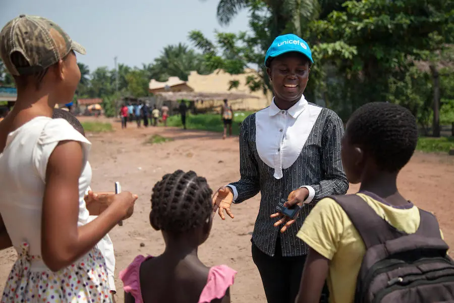 On 6 June 2018 in the Democratic Republic of the Congo, Hornelie Mpiko (in the UNICEF cap), 17, a UNICEF-supported radio reporter/educator, talks to children in Mbandaka. unicef, ebola, democratic republic of the congo
