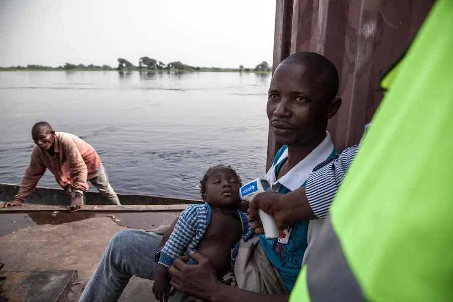 On 6 June 2018 in the Democratic Republic of the Congo, a baby has his temperature screened with a UNICEF-provided infrared thermometer, in order to reduce the risk of Ebola Virus Disease (EVD) transmission at the main port in Mbandaka. unicef, ebola, democratic republic of the congo