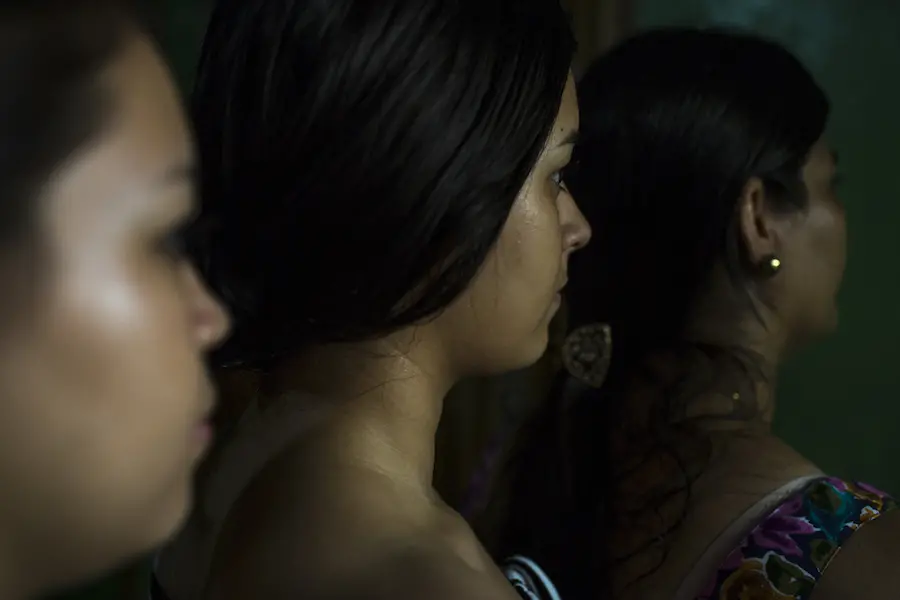 Three Women Facing Away From Camera