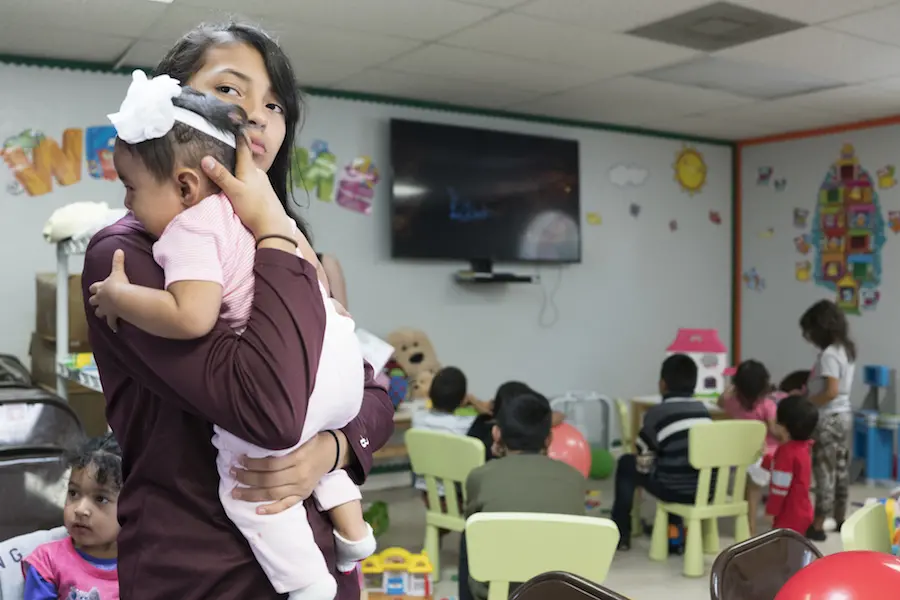 children play at a UNICEF-supported center in McAllen, Texas, where newly arrived migrant families from Central America can receive services . children play at a UNICEF-supported center in McAllen, Texas, where newly arrived migrant families from Central America can receive services .