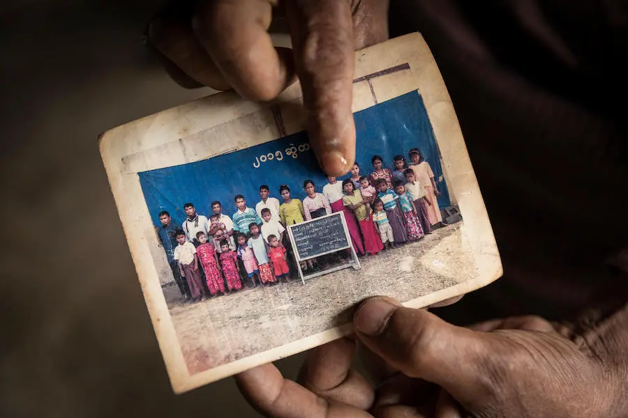 Rohingya refugee Nur Mohamed points to his 13-year-old niece in a family photo. She disappeared while waiting in a food line at Kutupalong refugee camp in Cox's Bazar, Bangladesh. UNICEF, Rohingya, children in conflict