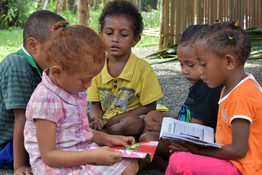 In July 2018, a group of young preschoolers read at Ladava Early Learning Center, supported by UNICEF, in Alotau, Milne Bay Province, Papua New Guinea. 