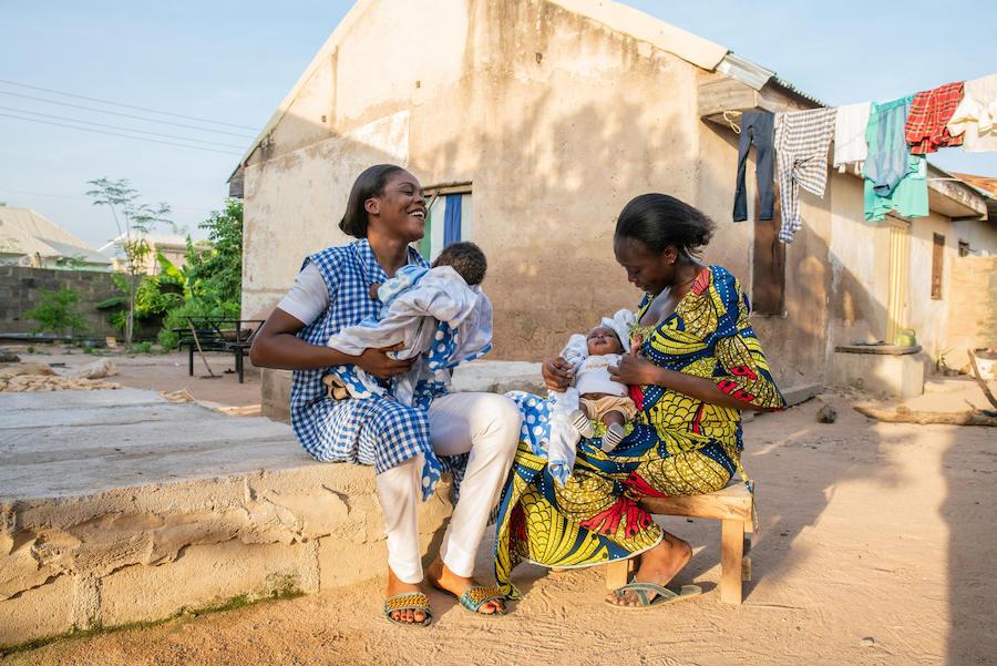 Community health worker Amilia Mathew (left) visits a new mother who recently delivered twins in the UNICEF-supported Nana As'mau clinic in Yola, Nigeria. 