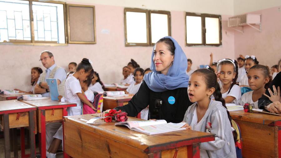 At the Ibn Zaidoon School in Aden, Yemen, girls attend class with UNICEF Regional Director for Middle East and North Africa Geert Cappelaere (adult on left) and UNICEF Representative in Yemen Merixell Relano (adult on right).