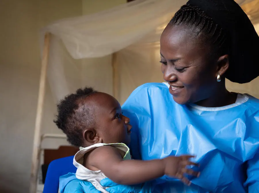 On 6 December 2018, at a UNICEF supported crèche in Beni, in the eastern DRC, Kavira Langa Jemima, an Ebola survivor, cares for 6-month-old Joshua, who's mother is undergoing treatment for Ebola. UNICEF, Democratic Republic of the Congo, DRC, Ebola