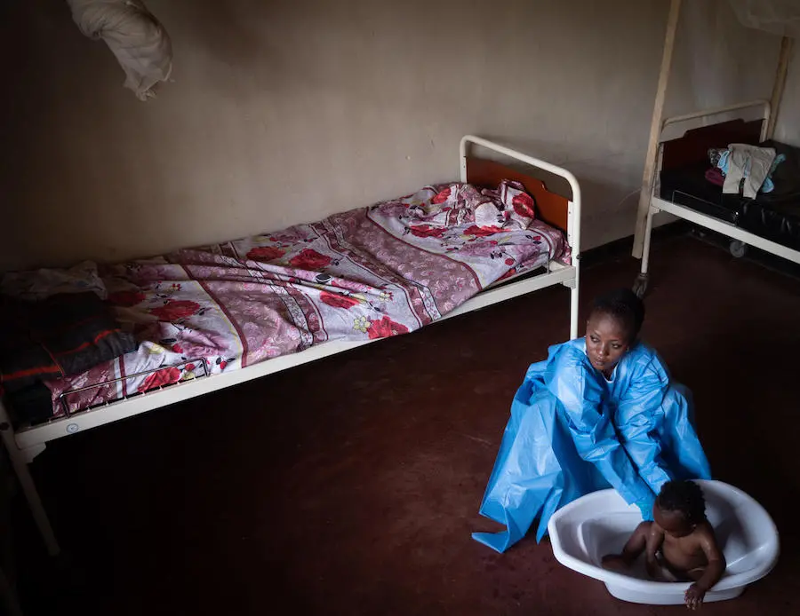 On 6 December 2018, at a UNICEF supported crèche in Beni, in the eastern DRC, Kavira Langa Jemima, an Ebola survivor, bathes 6 month old Josue, who's mother is undergoing treatment for Ebola. UNICEF, Democratic Republic of the Congo, DRC, Ebola