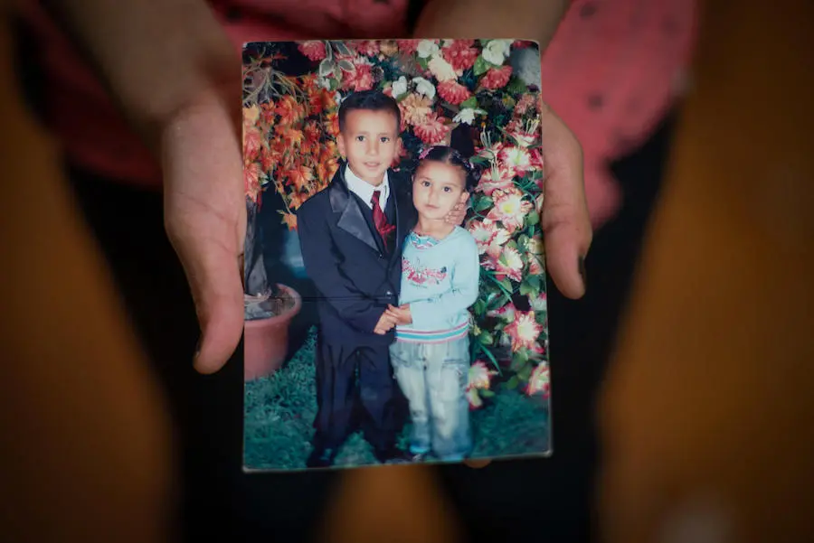 In Jordan's Za'atari refugee camp, Hala, 11, holds a photo of herself and her older brother in Syria. In Jordan's Za'atari refugee camp, Hala, 11, holds a photo of herself and her older brother in Syria.