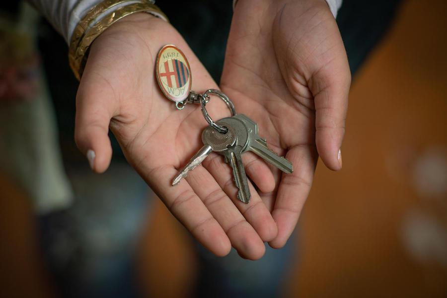 In Jordan's Za'atari Refugee Camp, Rudaina, 11, holds the keys to her old house in Syria.