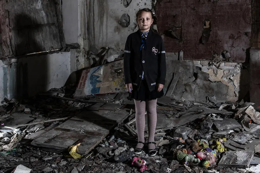 Masha, 11, stands in the kindergarten room of her school in Novotoshkivske, eastern Ukraine. In 2015, the room took a direct hit from a shell that caused massive damage to the surrounding residential area. UNICEF, Ukraine, children in conflict