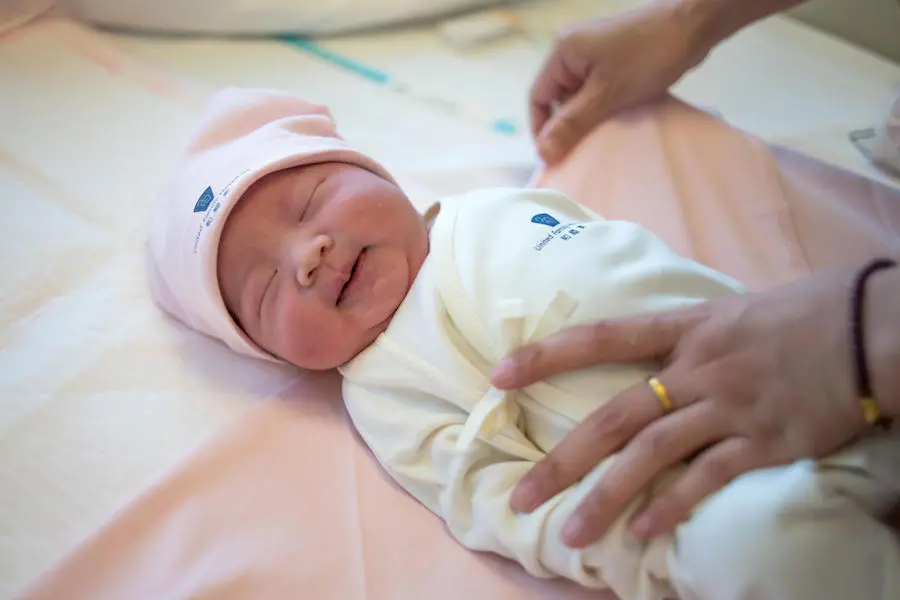 On 1 January 2019 in China, newborn baby girl Li Xin Yao is dressed and swaddled, after being born by caesarian section at 10:19am at the Beijing United Family Hospital in Beijing. UNICEF, China, newborn health